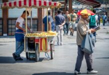 Sokak Satıcılarının Şehir Kültüründeki Yeri ve Önemi Şehir yaşamının vazgeçilmez bir parçası olan sokak satıcıları, hem ekonomik hem de kültürel açıdan önemli bir role sahiptir. Geniş bir ürün yelpazesi sunmaları, günlük hayatta pratik çözümler sağlamaları ve şehrin dinamizmini yansıtmaları, onları kent kimliğinin ayrılmaz bir unsuru haline getirir. Özellikle büyük şehirlerde sabahın erken saatlerinden gece geç saatlere kadar çalışan bu satıcılar, yerel ekonomiye de ciddi katkı sağlar. Konulu bir haber görseli.
