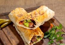 Dürüm, Türk mutfağının en popüler sokak lezzetlerinden biri olarak bilinir. Genellikle lavaş veya yufka ekmeği içinde sunulan bu hızlı atıştırmalık, hem doyurucu hem de pratik bir yemek seçeneği oluşturur. Tarih boyunca Orta Doğu mutfağı ile etkileşim içinde olan dürüm, zamanla Türkiye’de kendine özgü bir biçim kazanmıştır. Konulu bir haber görseli.