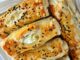 Peynirli Börek Lezzetinin Sofralardaki Vazgeçilmez Yeri Peynirli börek, Türk mutfağının en özel ve geleneksel lezzetlerinden biridir. Çay saatlerinin en çok aranan eşlikçisi, misafir sofralarının baş tacı ve sabah kahvaltılarının olmazsa olmazı olan bu börek çeşidi, pratik hazırlanışıyla da gönülleri fetheder. Kat kat yufkaların arasına serilen lezzetli peynir harcı sayesinde ortaya çıkan doyurucu tat, hem günlük öğünlerde hem de özel davetlerde sıklıkla tercih edilir. Bugün, peynirli böreğin tarihinden yapılışına, farklı çeşitlerinden püf noktalarına kadar pek çok detayı keşfedeceğiz. Konulu bir haber görseli.