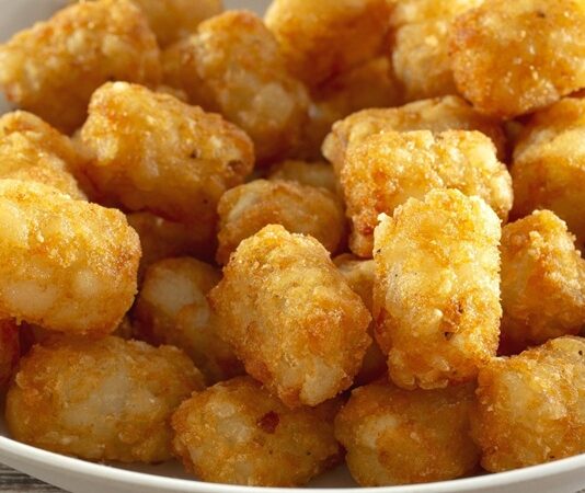 Tater tots, Amerikan mutfağının en ikonik atıştırmalıklarından biri olarak öne çıkar. Küçük, silindirik patates parçacıklarından oluşan bu lezzet, ilk olarak 1950’lerde ABD’de ortaya çıkmıştır. Patentli bir tarifle üretilen tater tots, kısa sürede fast food zincirlerinin vazgeçilmez menü öğelerinden biri haline gelmiştir. Konulu bir haber görseli.