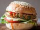 Veggie Burger, Sağlıklı Lezzetlerin Yeni Yıldızı Son yıllarda sağlıklı beslenme ve bitkisel bazlı ürünlere olan ilgi büyük bir hızla artıyor. Bu ilgi, fast food sektöründe de kendini gösteriyor. Özellikle veggie burger seçenekleri, et tüketimini azaltmak isteyen veya tamamen bitkisel beslenen kişiler için cazip bir alternatif haline gelmiş durumda. Hem fast food zincirlerinde hem de gurme restoranlarda menülere giren bu burgerler, etin yerini alan zengin bitkisel malzemeleriyle dikkat çekiyor. Konulu bir haber görseli.